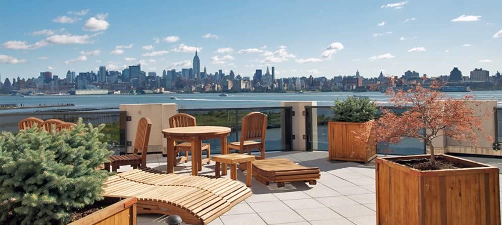 a balcony with a table and chairs and a view of the city